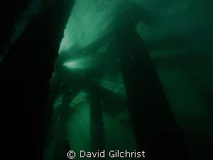 Silhouette, beneath the Piers at the Swing Bridge site, W... by David Gilchrist 